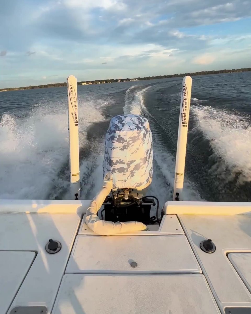 Outer Envy Blue Digital Camo vented outboard motor cover fitted on an outboard running at speed