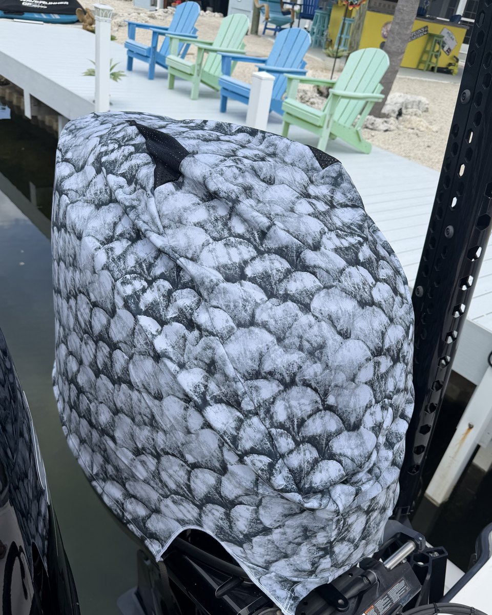 Outer Envy Grey Fish Scale vented outboard motor cover fitted on an outboard at the dock
